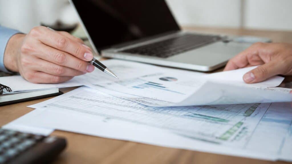 Close-up of property feasibility and risk assessment documents spread across a desk