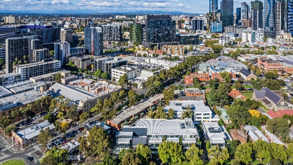 image contrasting a regional Australian town with a capital city apartment strip, reflecting the two-speed property market