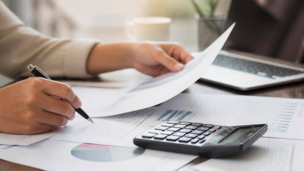 Investor reviewing property investment strategy documents and superannuation paperwork